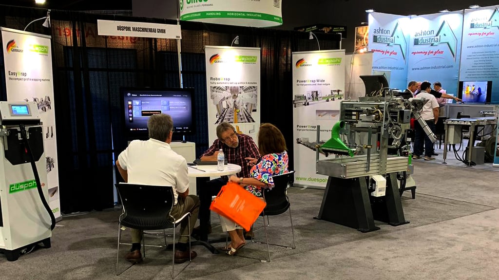 A Sales Manager is talking to people at a fair. 