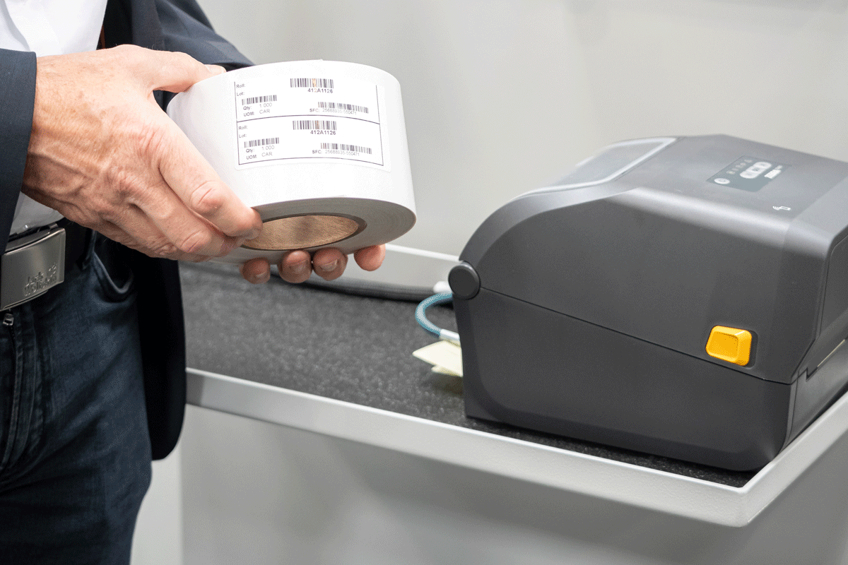 Reel with barcode and printer